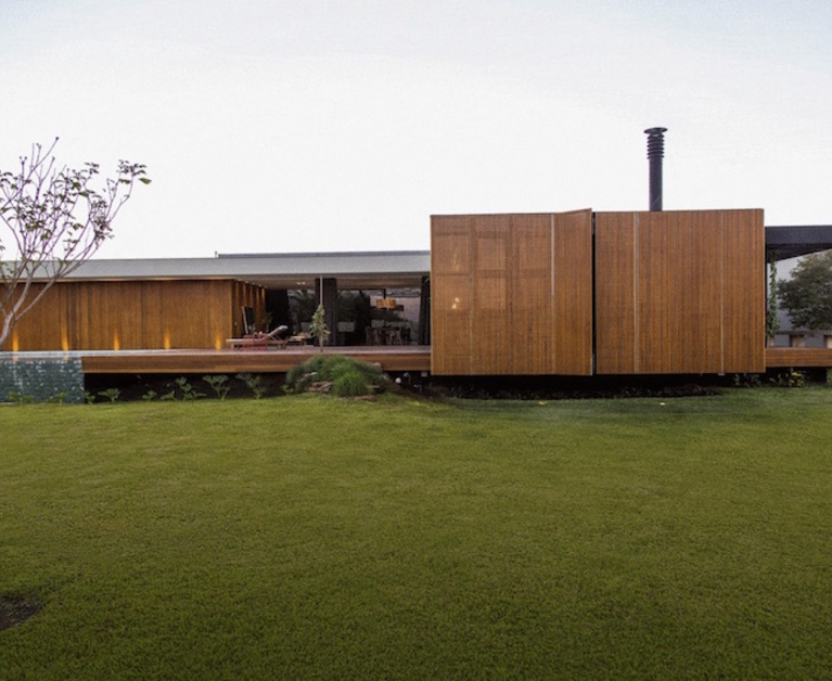 A contemporary house with a folding wood facade