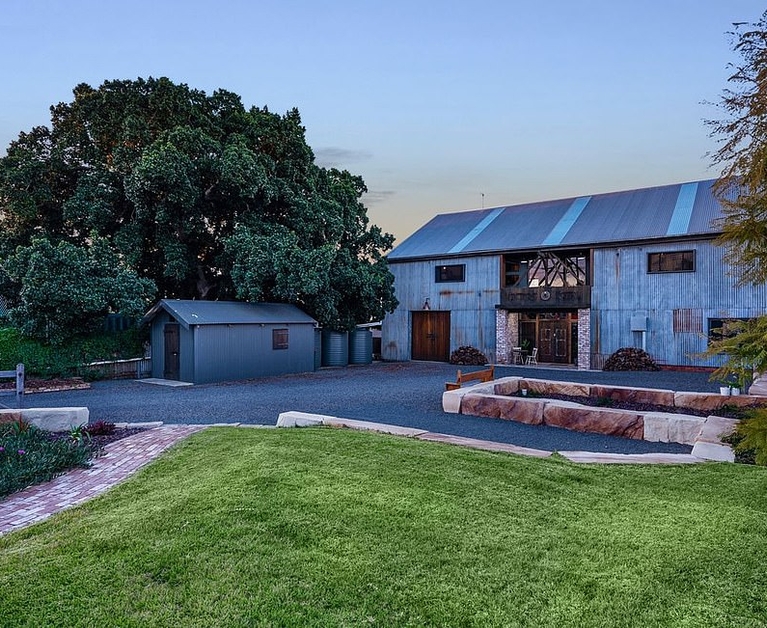 Behind this historic hay shed hides an incredible family home